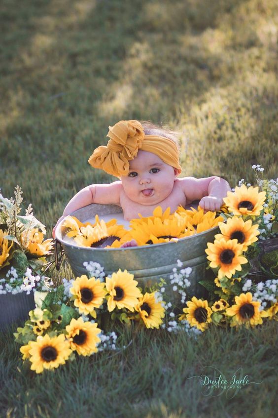 baby bathing with sunflowers