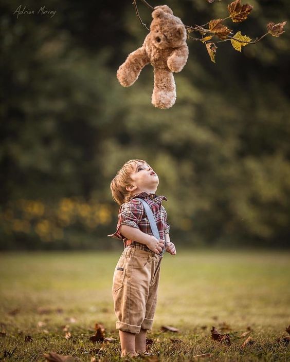 download cute baby boy trying to get teddy bear