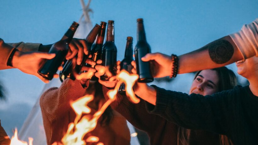 hình ảnh uống bia, uống rượu cụng chai bia bên cạnh đống lửa