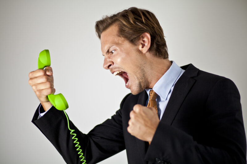 Businessman screaming at phone